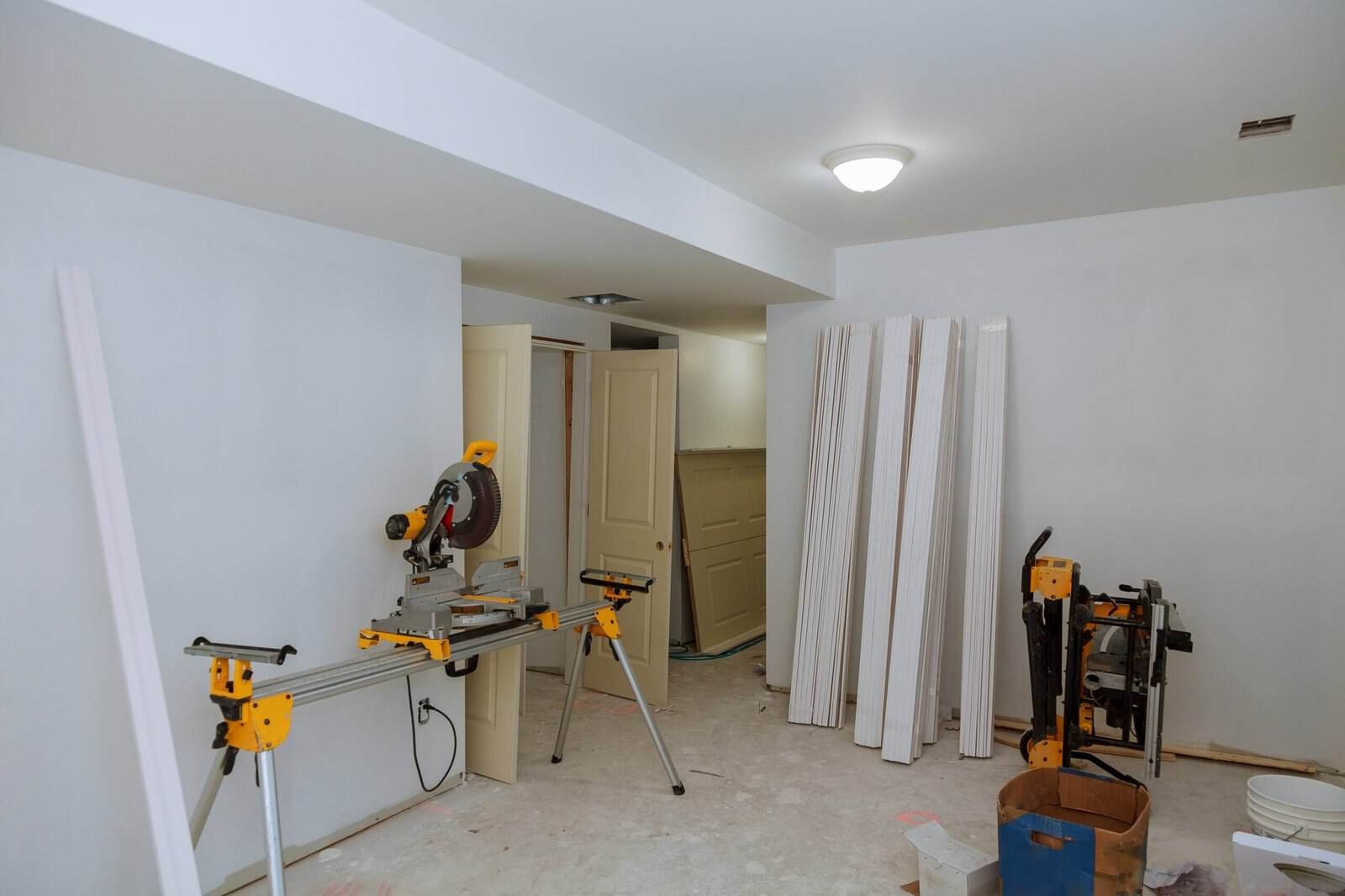 Construction site with drywall panels and tools for drywall installation.